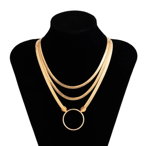 Detailed view of triple-layered golden snake chain necklace with a round ring pendant