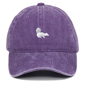 Close-up of squirrel embroidery on washed cotton fabric of the purple baseball cap