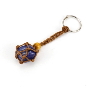Detail of hand-woven brown rope mesh pouch with blue crystal stone keychain