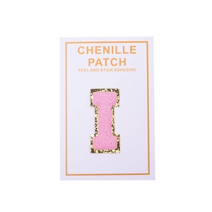 Detail of pink chenille letter I patch with gold sequins and self-adhesive backing