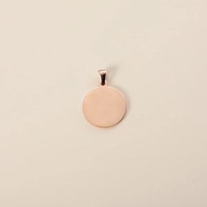 Polished rose gold stainless steel round pet ID tag with clasp on beige background