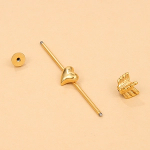 Detailed components of golden stainless steel heart and wing industrial barbell earring