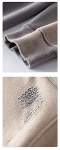 Macro-opname van grijze 360g katoenen hoodie met geribbelde manchetten en borduurdetails