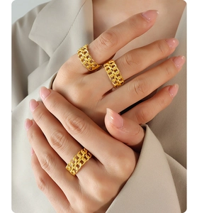 Close-up of three gold double-layer hollow chain rings worn by a model in French style