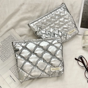 Detail of silver quilted heart patterns on water-resistant PU leather pouches