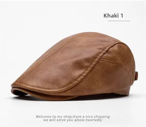 Detail of khaki leather newsboy cap showing textured lychee grain and fine stitching