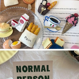 Detailed view of 3D food-shaped fridge magnets featuring espresso and bread models