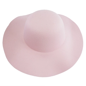 Detailed texture of light pink wool felt wide brim sun hat with a round minimalist crown