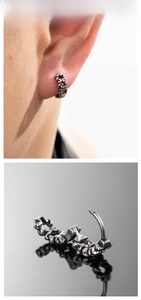 Detail of vintage star cross huggie earring in oxidized silver finish for a gothic look