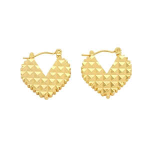 Detail view of heart-shaped gold earrings with studded texture and secure latch closure