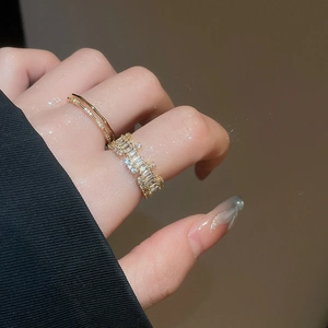 Close-up of stacked 18k gold plated rings with baguette cut zircon and pavé setting