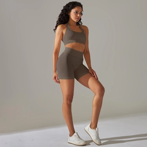 Close-up of seamless knitted texture on coffee brown yoga sports bra and shorts
