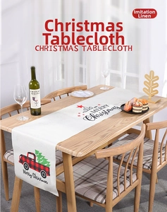 Detail of faux linen Christmas table runner with red truck and Merry Christmas print