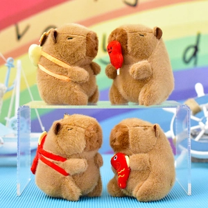 Four cute brown capybara plush toy keychains displayed on a clear acrylic stand
