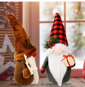 Close-up of reindeer Christmas gonk and gnome with plaid hat holding gift box decor