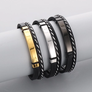 Detailed view of layered leather bracelets with polished gold, silver, and black metal plates