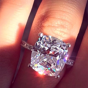 Close-up of cushion cut ring with rose gold plating and pink zirconia stones