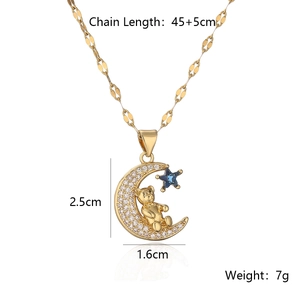 Detail of gold moon bear pendant with white zircon micro-paving and blue star accent
