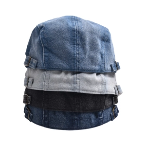 Vertical stack of denim newsboy caps in light blue, gray, black, and dark blue colors