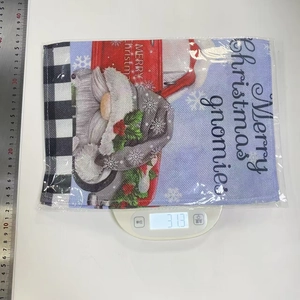 Detailed view of Merry Christmas gnomes placemat with festive red truck on digital scale