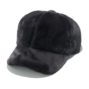 Close-up of the thick black faux fur texture and curved brim of the baseball cap