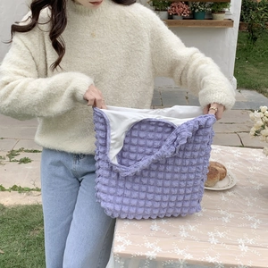 Detail view of purple cloud bubble texture shoulder bag interior and spacious capacity