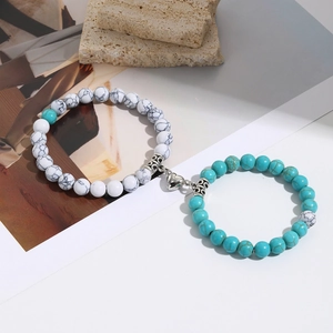 Detail view of heart shaped magnetic clasp on marble and turquoise beaded bracelets