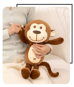 Close-up of soft plush monkey toy being held to show high-quality fabric and cuddly size
