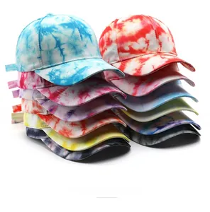 Detail of colorful tie-dye cotton baseball caps in various color combinations with curved brims