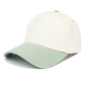 Detail view of two-tone canvas baseball cap with beige crown and sage green curved brim