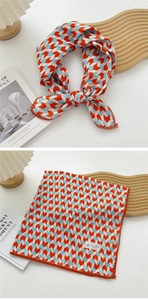 Detailed view of geometric square scarf with red lace edge and arrowhead patterns