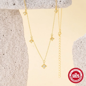 Minimalist S925 sterling silver gold star necklace with white zircon on a stone pedestal