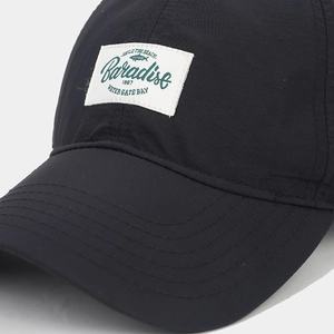 Close-up of Paradise fish patch on quick-dry black nylon baseball cap detail