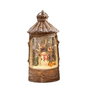 Vintage Christmas lantern with snowman, pine tree and squirrel inside a lighted snow globe