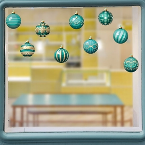 Teal and gold Christmas ball window stickers with snowflake patterns on a glass pane
