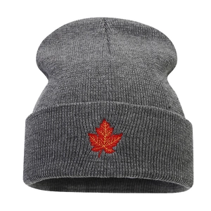 Gray ribbed knit beanie with red maple leaf embroidery on the front cuff for unisex