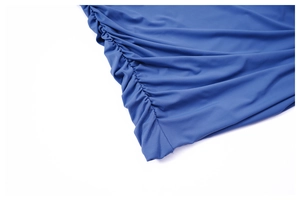 Close-up detail of side ruched design and elastic fabric texture on blue mini skirt