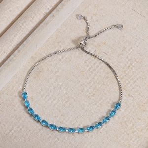 Detail of adjustable silver bolo bracelet with marquise-cut sea blue cubic zirconia stones