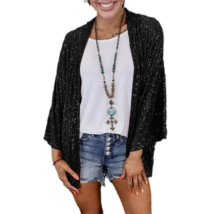 Detail of black sequined cardigan texture on a casual loose-fit women's jacket