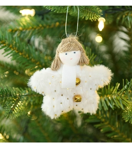 White plush star angel Christmas ornament with golden bell hanging on a green tree