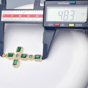 Macro shot showing the 48.3mm length measurement of a gold zircon cross pendant