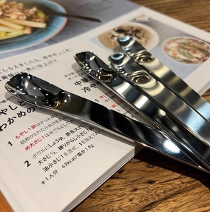 Close-up of long handle stainless steel dessert spoons with polished mirror finish
