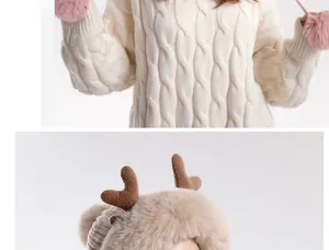 Detailed knit sweater with pink pom-pom sleeves and plush deer antler hat for winter