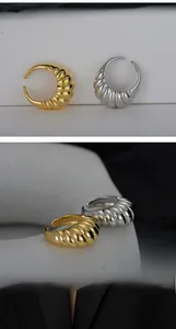 Detailed view of gold and silver spiral textured S925 rings with adjustable open bands