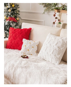 Detail of plush Christmas pillow covers with festive snowflake and reindeer embroidery