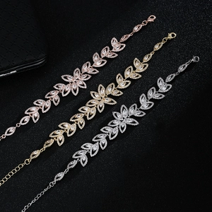 Detail of leaf-shaped zircon bracelets in rose gold, gold, and silver finishes