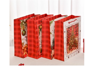 Detail of four Christmas gift bags with various holiday prints and red rope handles