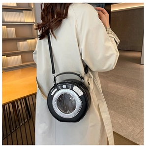 Detailed close-up of a unique washing machine shaped round crossbody bag in black PU leather