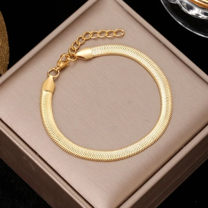 Flat gold snake chain bracelet with adjustable extender on a premium jewelry box