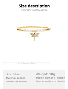 Detail of gold-plated dragonfly charm with zircon stones on a beaded pearl bracelet